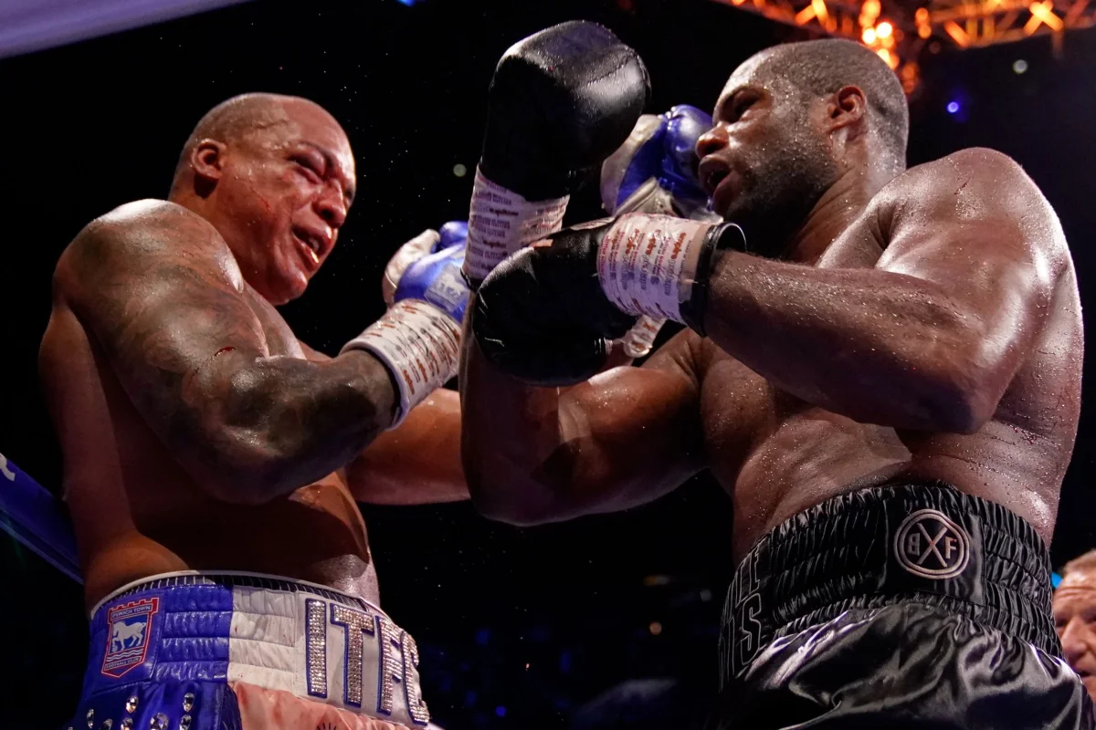 Britain's Daniel Dubois, right, lands a blow on Britain's Fabio Wardley during their WBO World Heavyweight boxing title bout in Manchester, Saturday, May 9, 2026. (AP Photo/Dave Thompson)