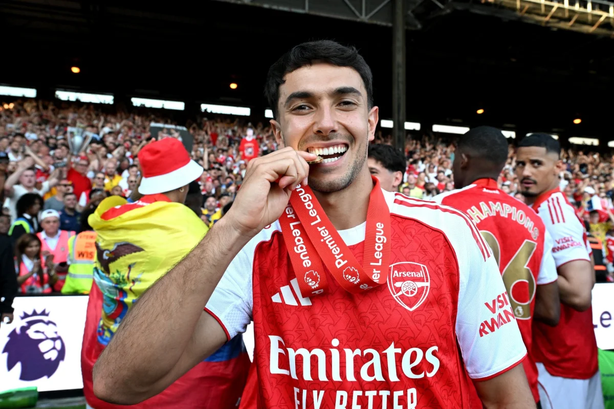 LONDON, ENGLAND - MAY 24: Martin Zubimendi of Arsenal bites his Premier League winners medal as he celebrates, as Arsenal are crowned the Champions of the Premier League for the 2025/26 Season, after the Premier League match between Crystal Palace and Arsenal at Selhurst Park on May 24, 2026 in London, England. (Photo by David Price/Arsenal FC via Getty Images)